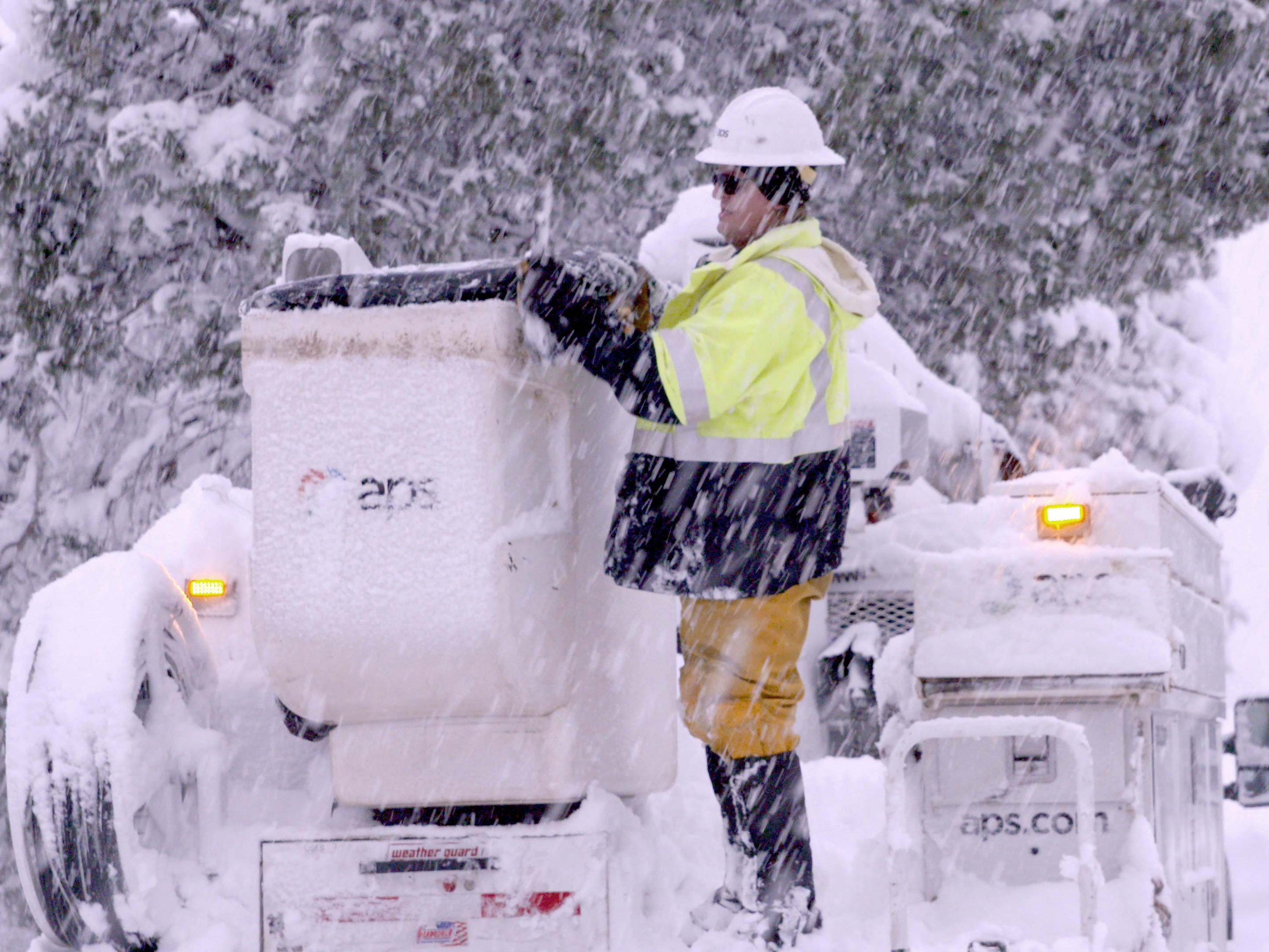 APS lineman working in the snow