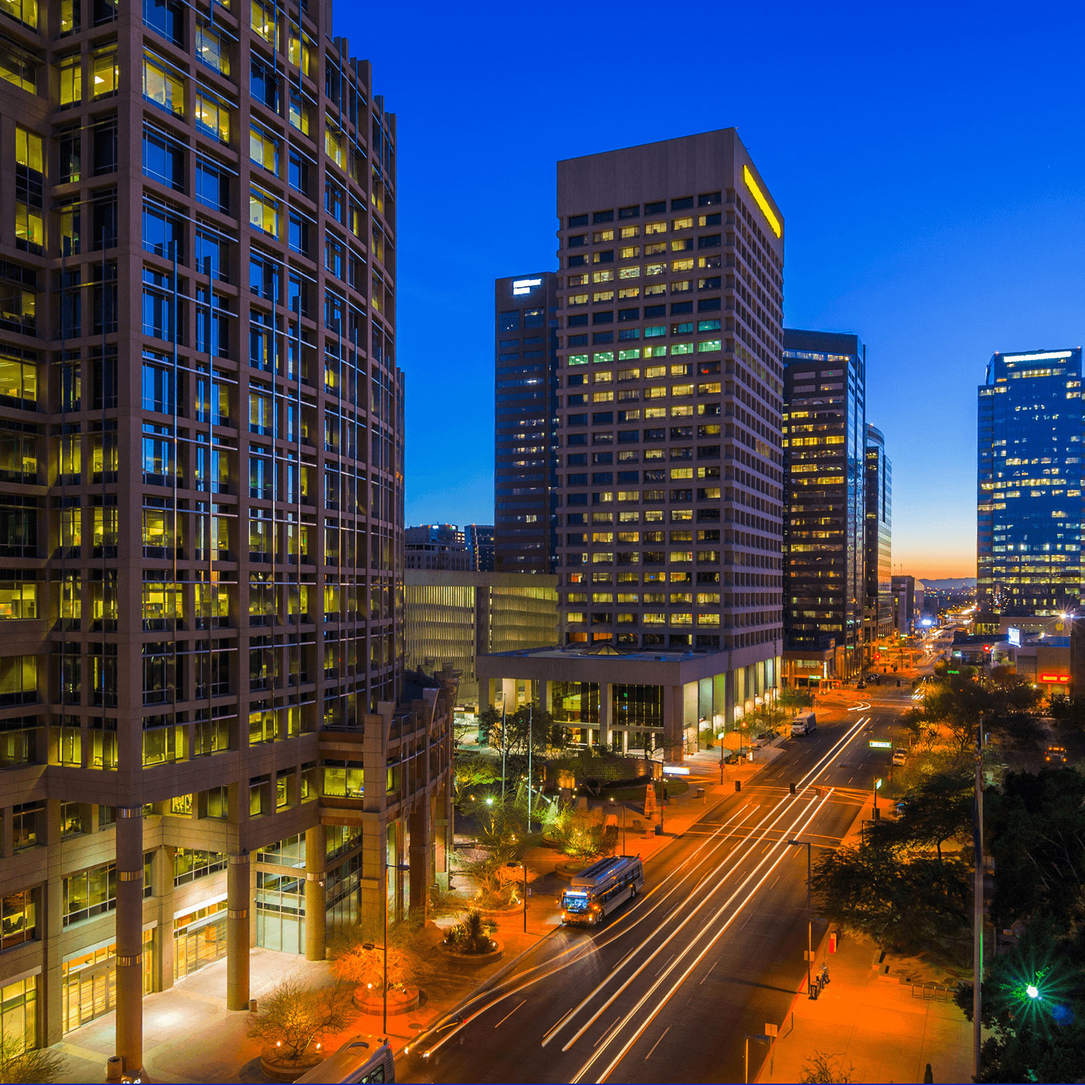 City buildings along a street at dusk.