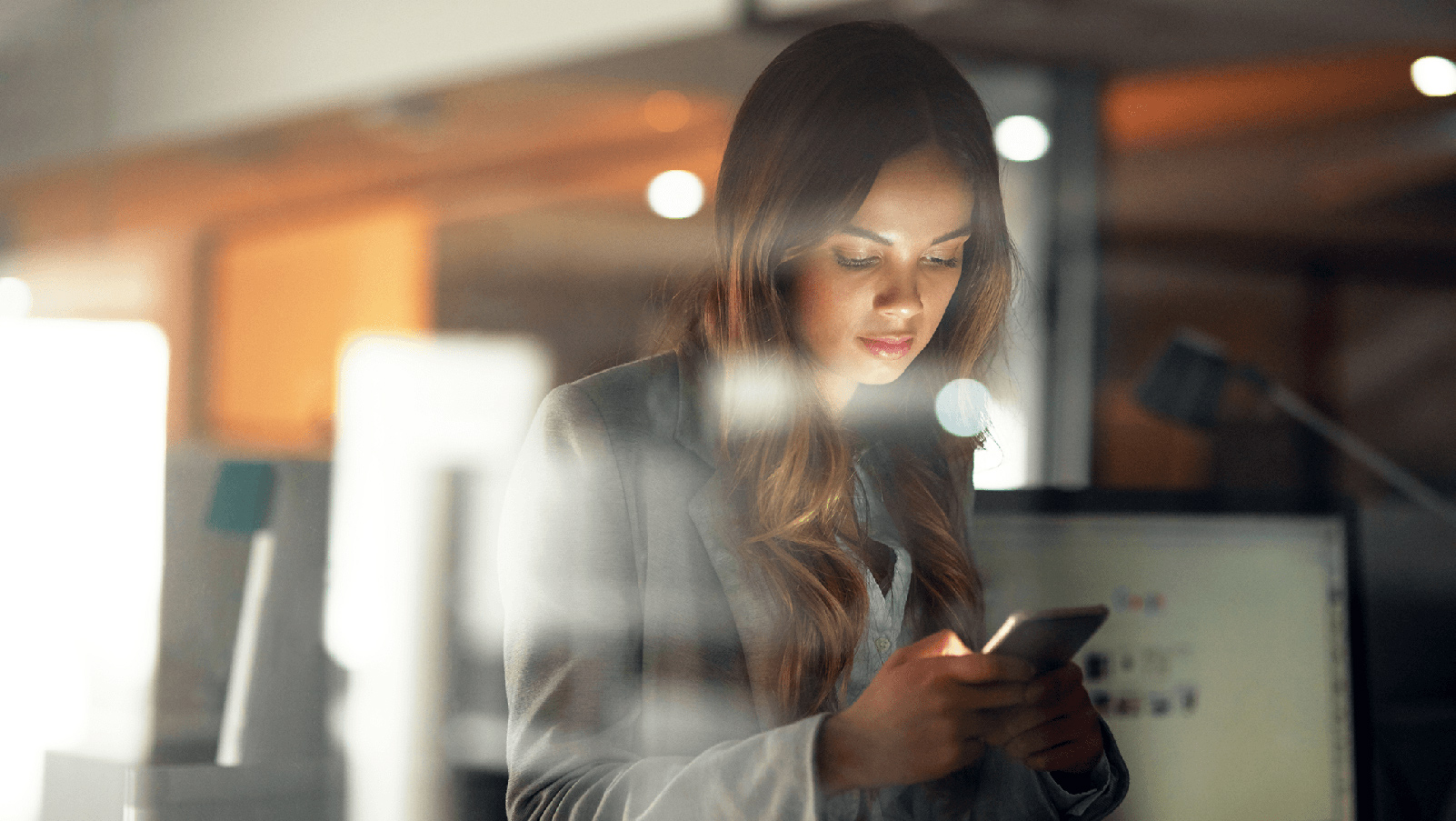 Woman checking her phone in an office.