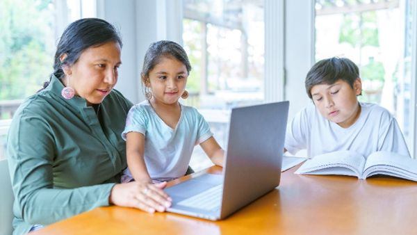 Family sitting at a laptop