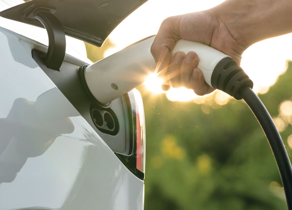 An EV car being plugged in