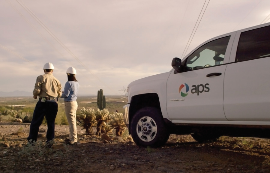 Employees in front of an APS truck