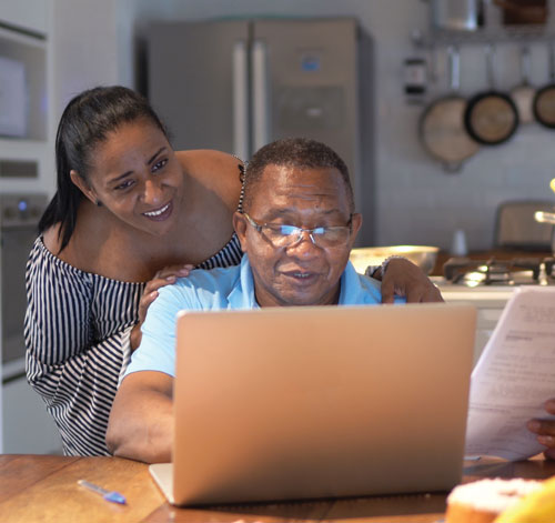 A family sitting at a computer