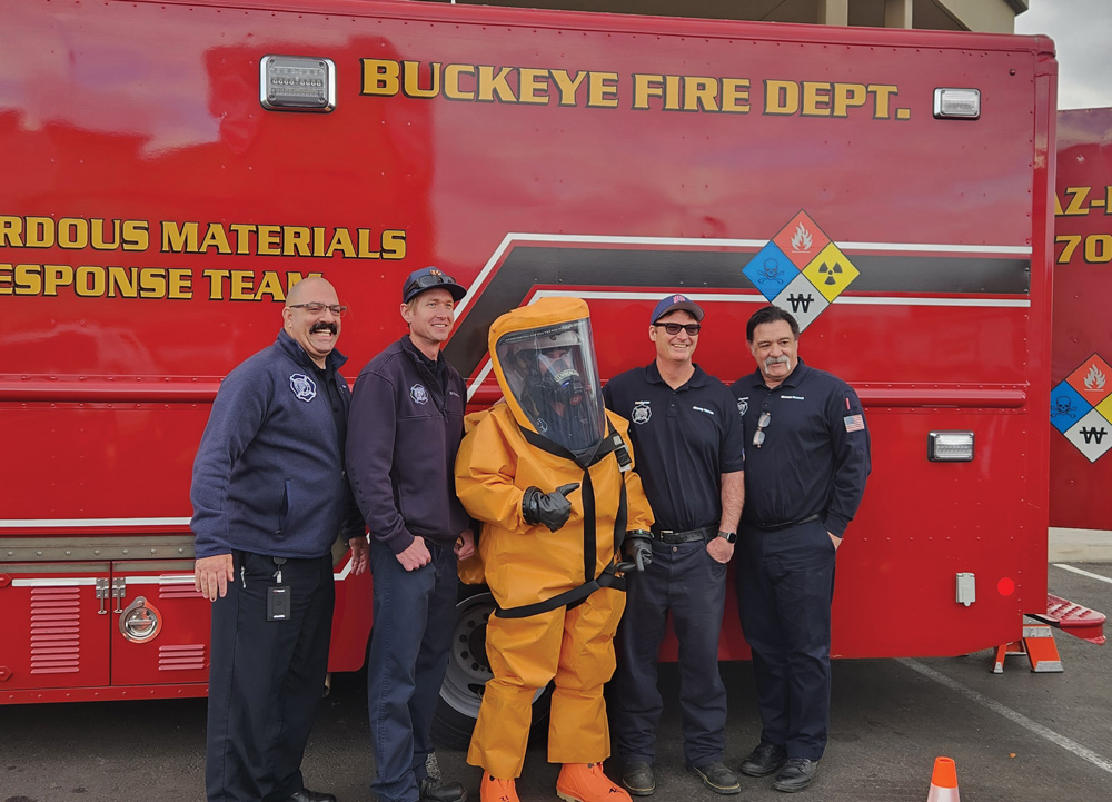 Firemen from Firehouse Subs in front of a fire truck