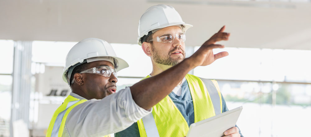 Construction workers surveying a space