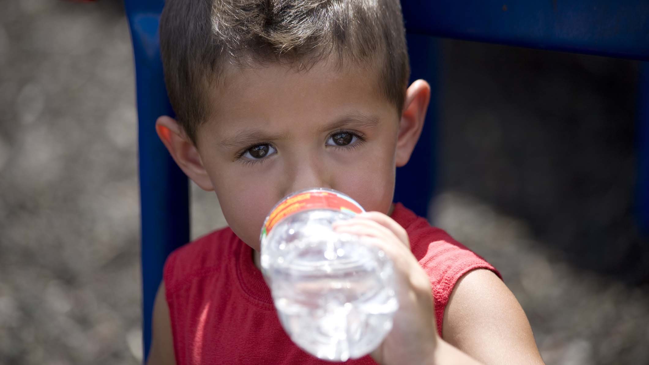 Little boy drinking a water bottle