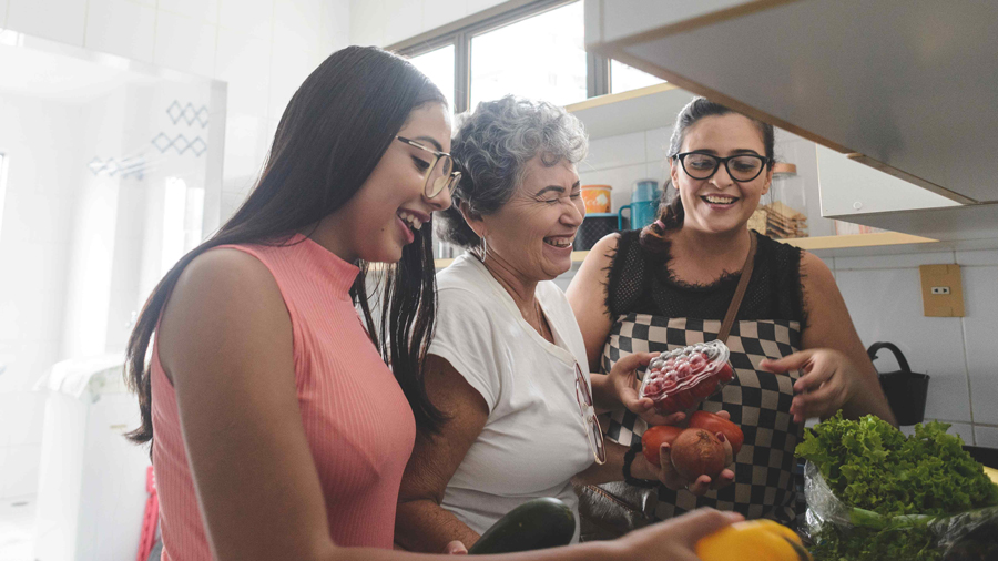 Mother and daughters having a good time together cooking in the kitchen