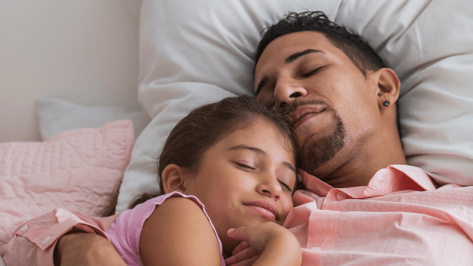 Father taking an afternoon nap with his daughter.