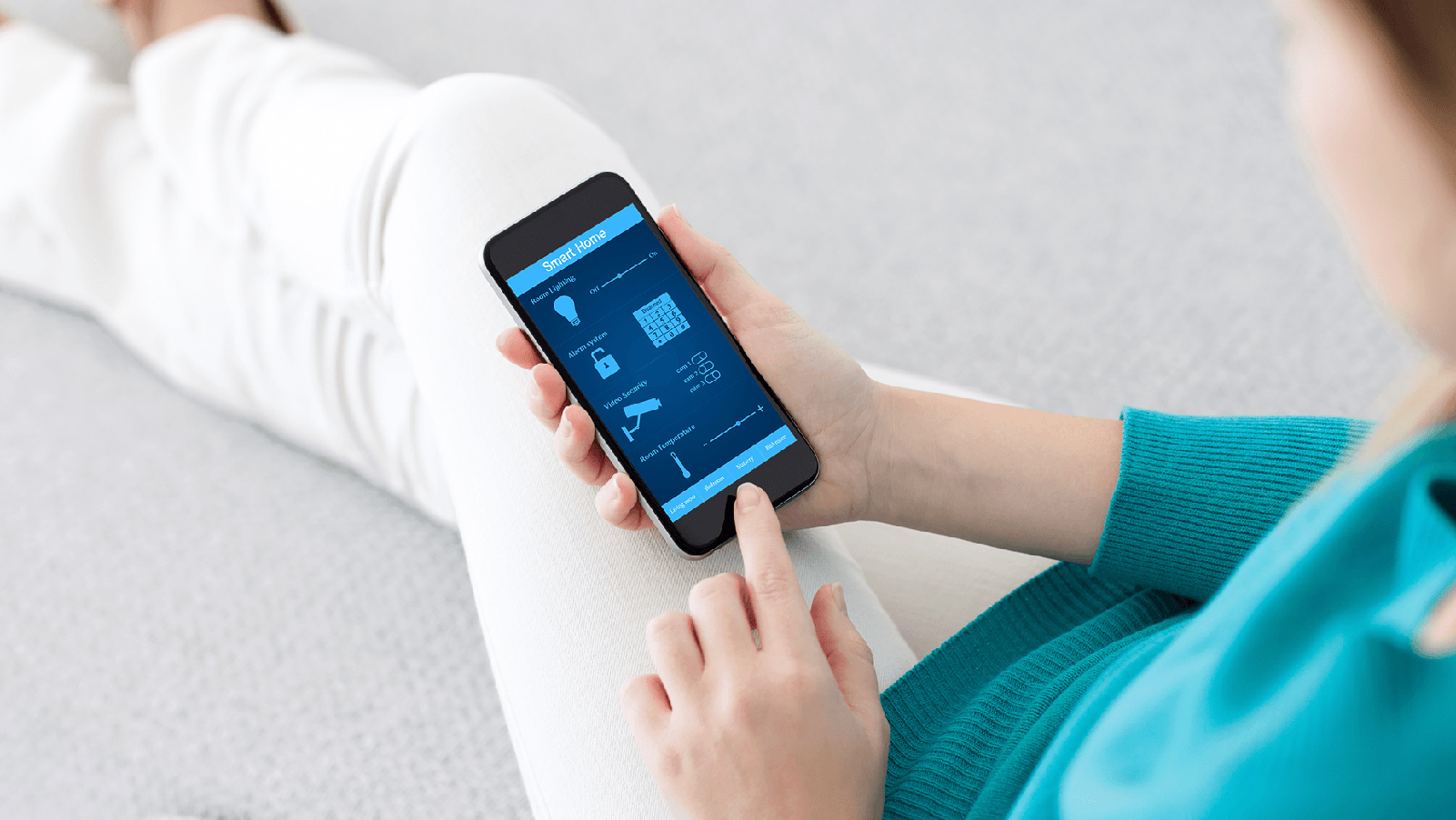 Woman using her phone too look at a Smart Home app.