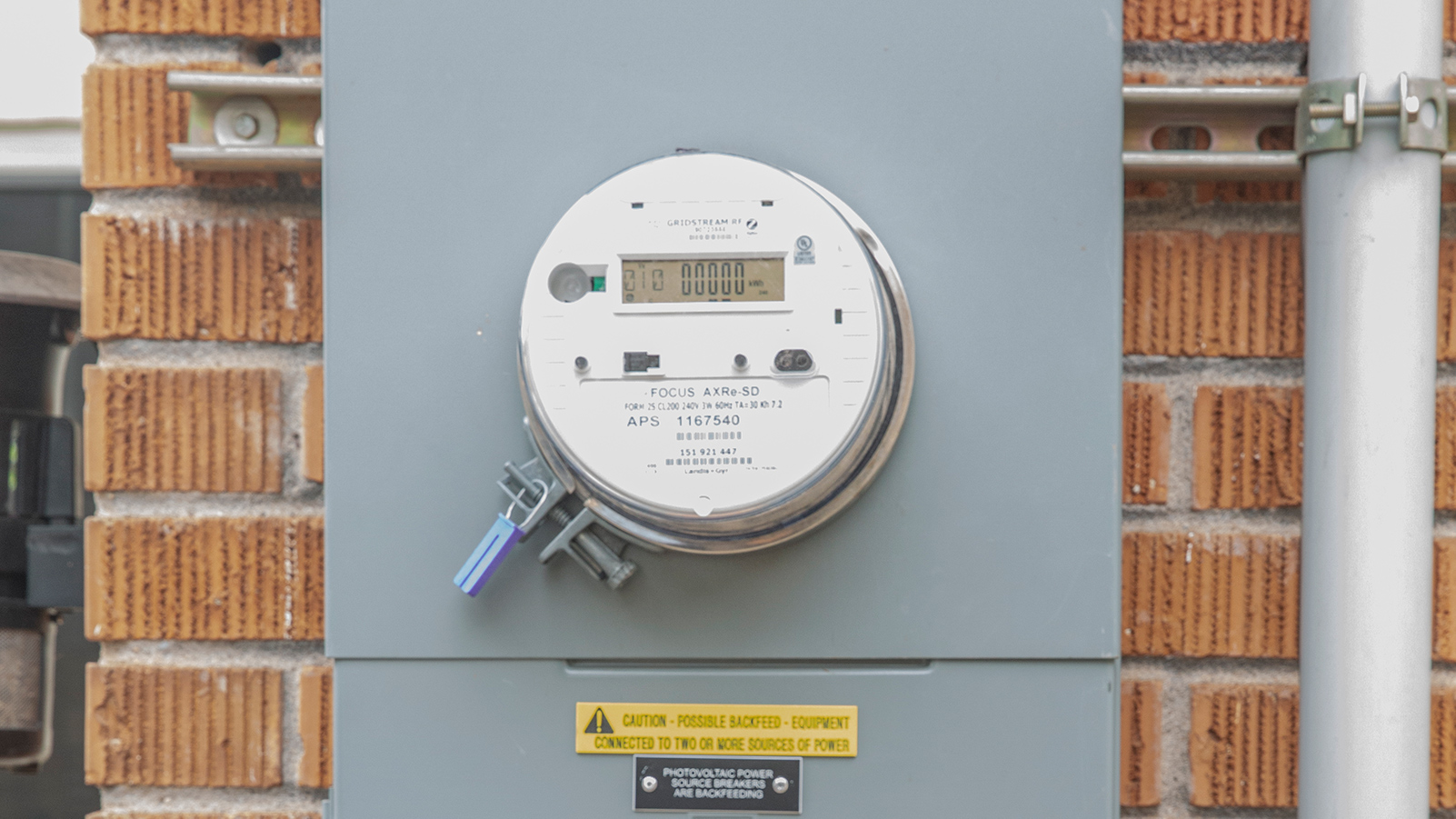 BiDirectional meter on a brick wall.