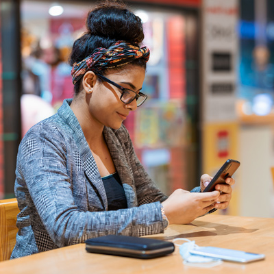 Woman in a shop checking her phone