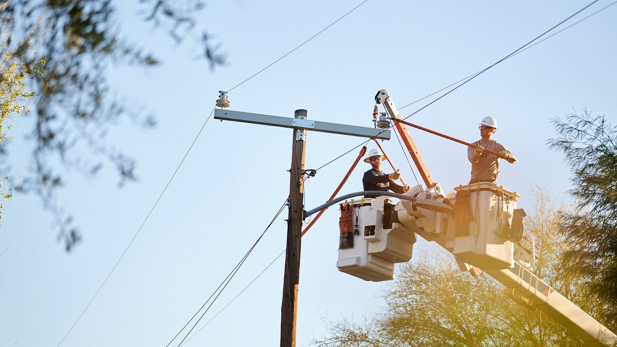 Two linemen working on a powerline