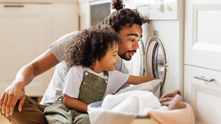 Father and son doing laundry
