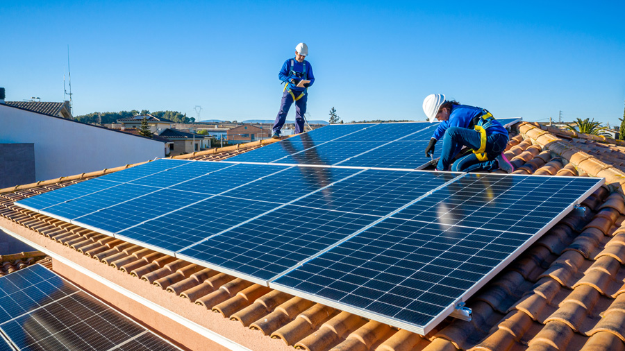 Professional installer putting solar panels on a roof