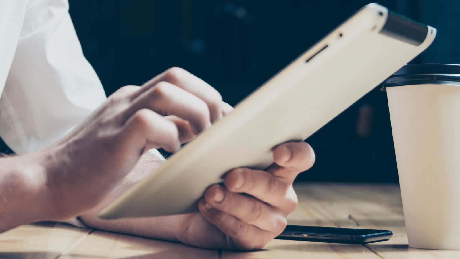 Hands holding a tablet