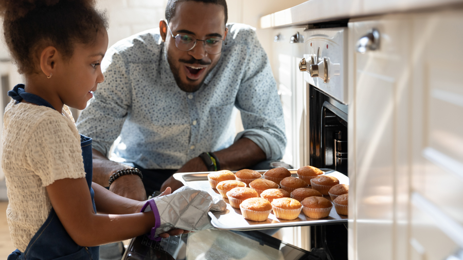 Father and daughter at the oven