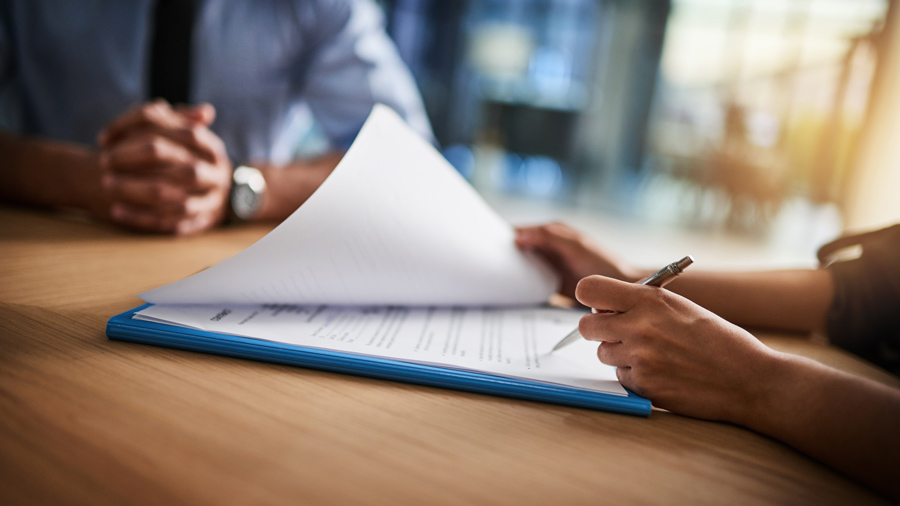 Person filling out paperwork.