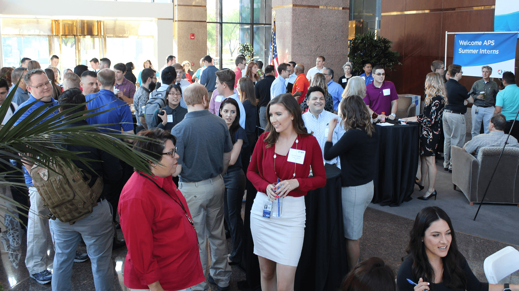 APS interns and employees talking at the summer internship welcome event.